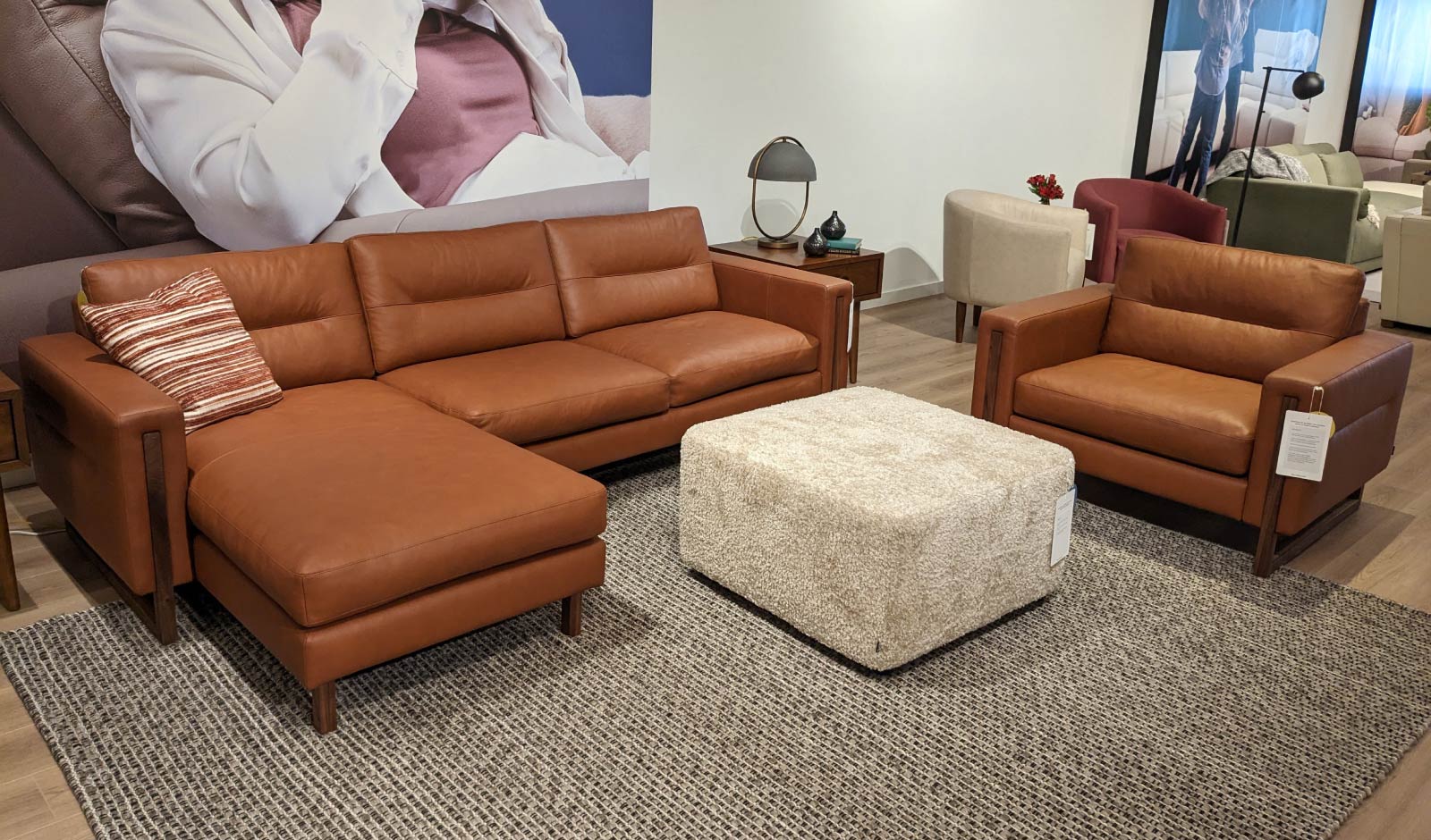 A tan leather sofa with wood accents and matching chair from Palliser